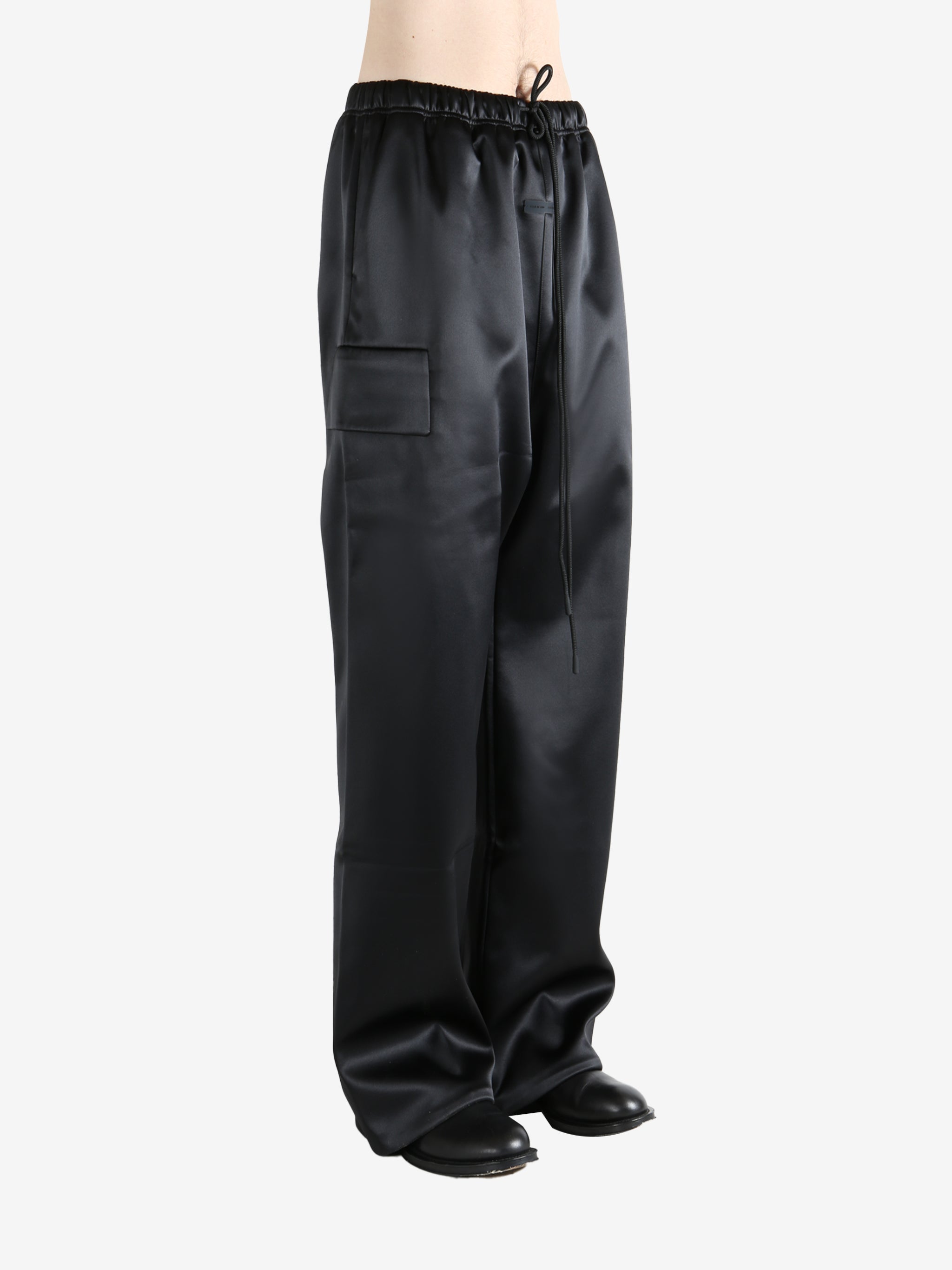 Black pants worn by a person, showing the pants fit