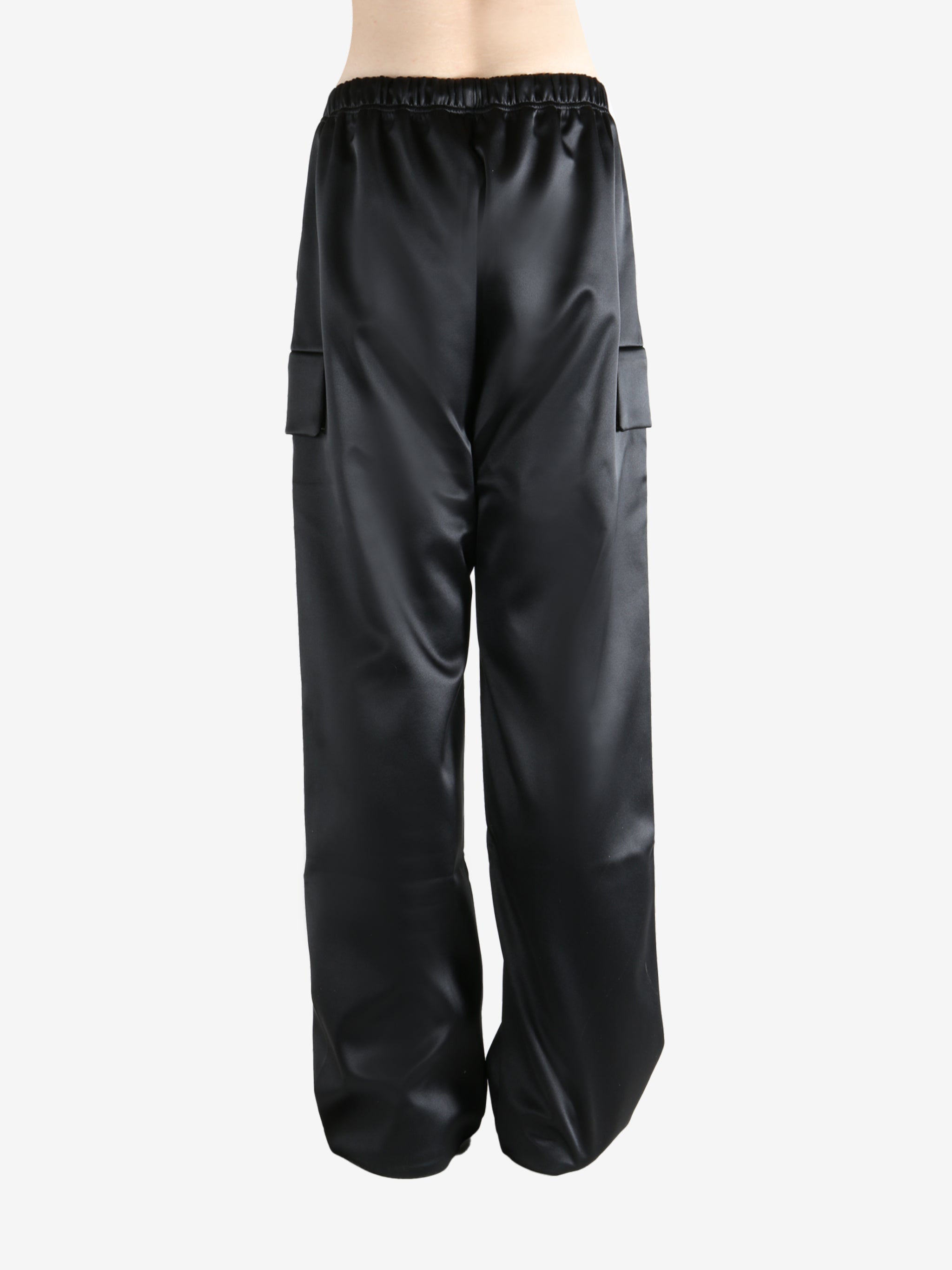 Black pants worn by a person, showing the pants fit