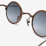 Close up of brown eyewear, showing texture of the copper and titanium fabric