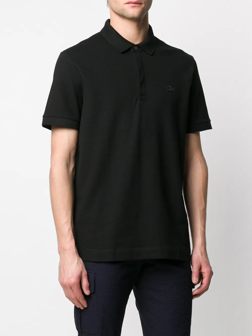 Black shirt worn by a person, showing the shirt's fit