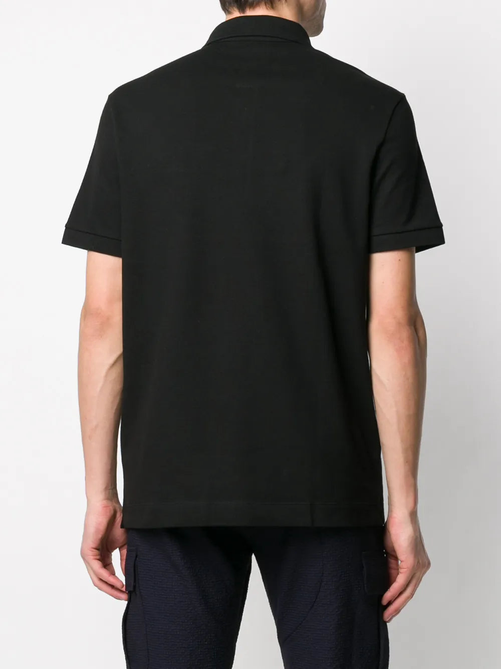 Black shirt worn by a person, showing the shirt's fit