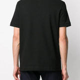 Black shirt worn by a person, showing the shirt's fit