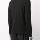 Black shirt worn by a person, showing the shirt's fit