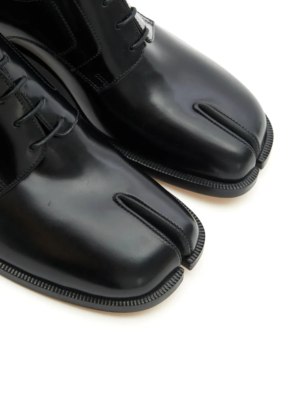 Close up of the black shoes, showing texture of the leather fabric