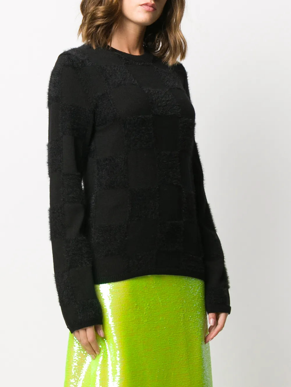 Black knitwear worn by a person, showing the knitwear fit
