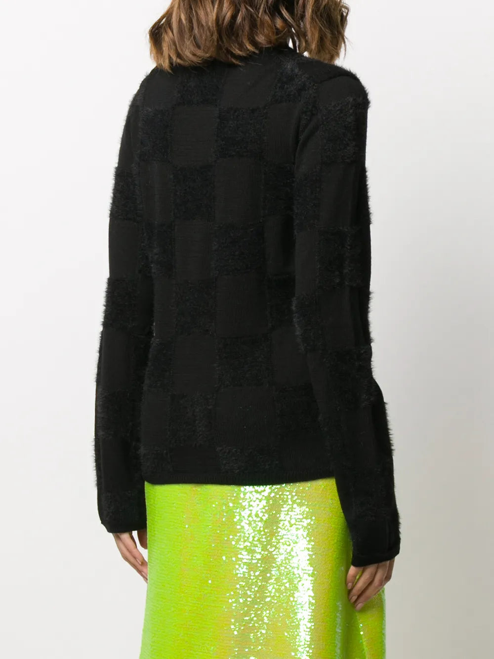 Black knitwear worn by a person, showing the knitwear fit