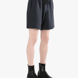 Black shorts worn by a person, showing the shorts' fit