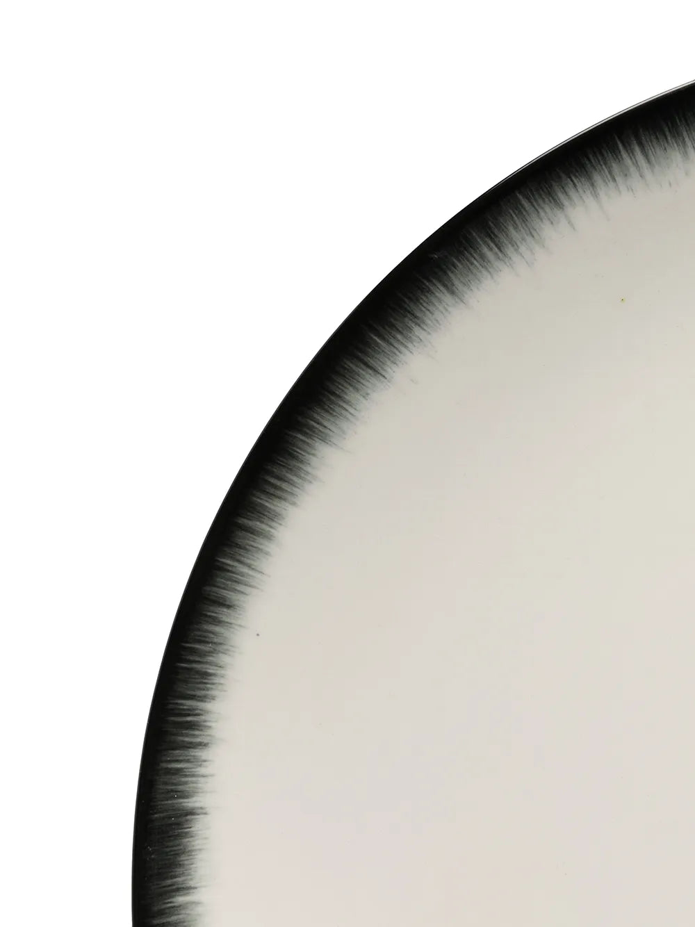 Close up of the white plate, showing texture of the ceramic