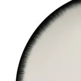 Close up of the white plate, showing texture of the ceramic