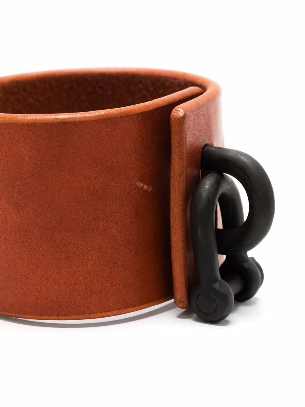 Close up of red bracelet, showing texture of the leather fabric