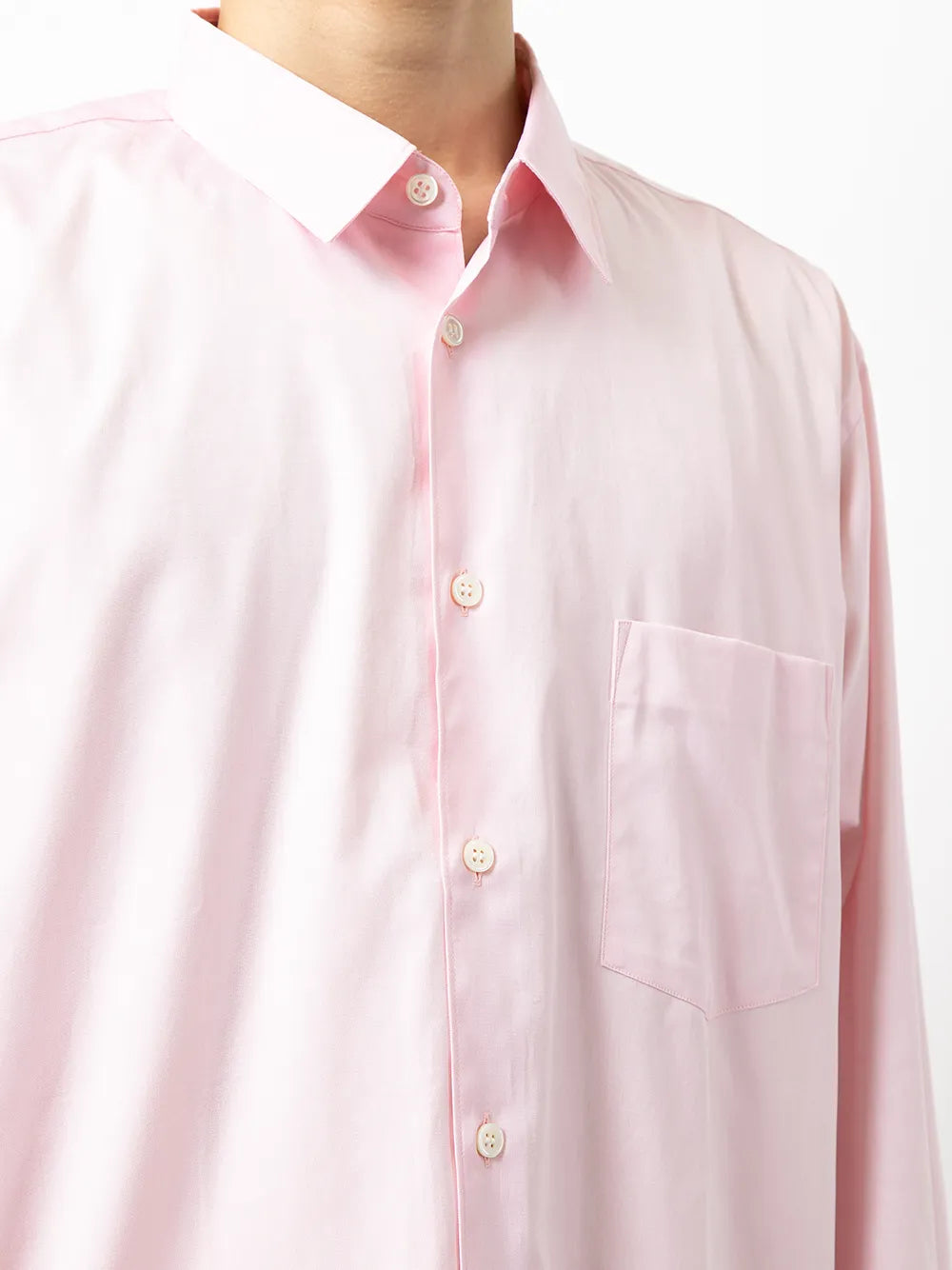 Close up of pink shirt, showing texture of the cotton fabric