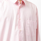 Close up of pink shirt, showing texture of the cotton fabric