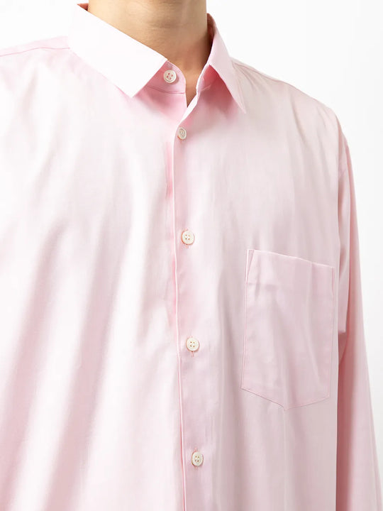 Close up of pink shirt, showing texture of the cotton fabric