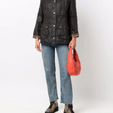 Brown jacket worn by a person, showing the jacket's fit