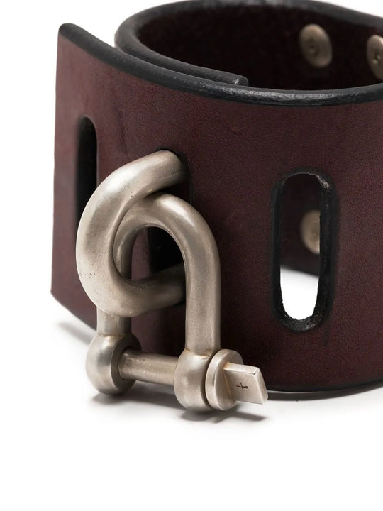 Close up of red bracelet, showing texture of the leather fabric