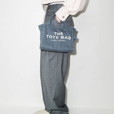 Blue bag, worn by a person, showing the bag's fit