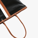 Close up of black bag, showing texture of the leather fabric