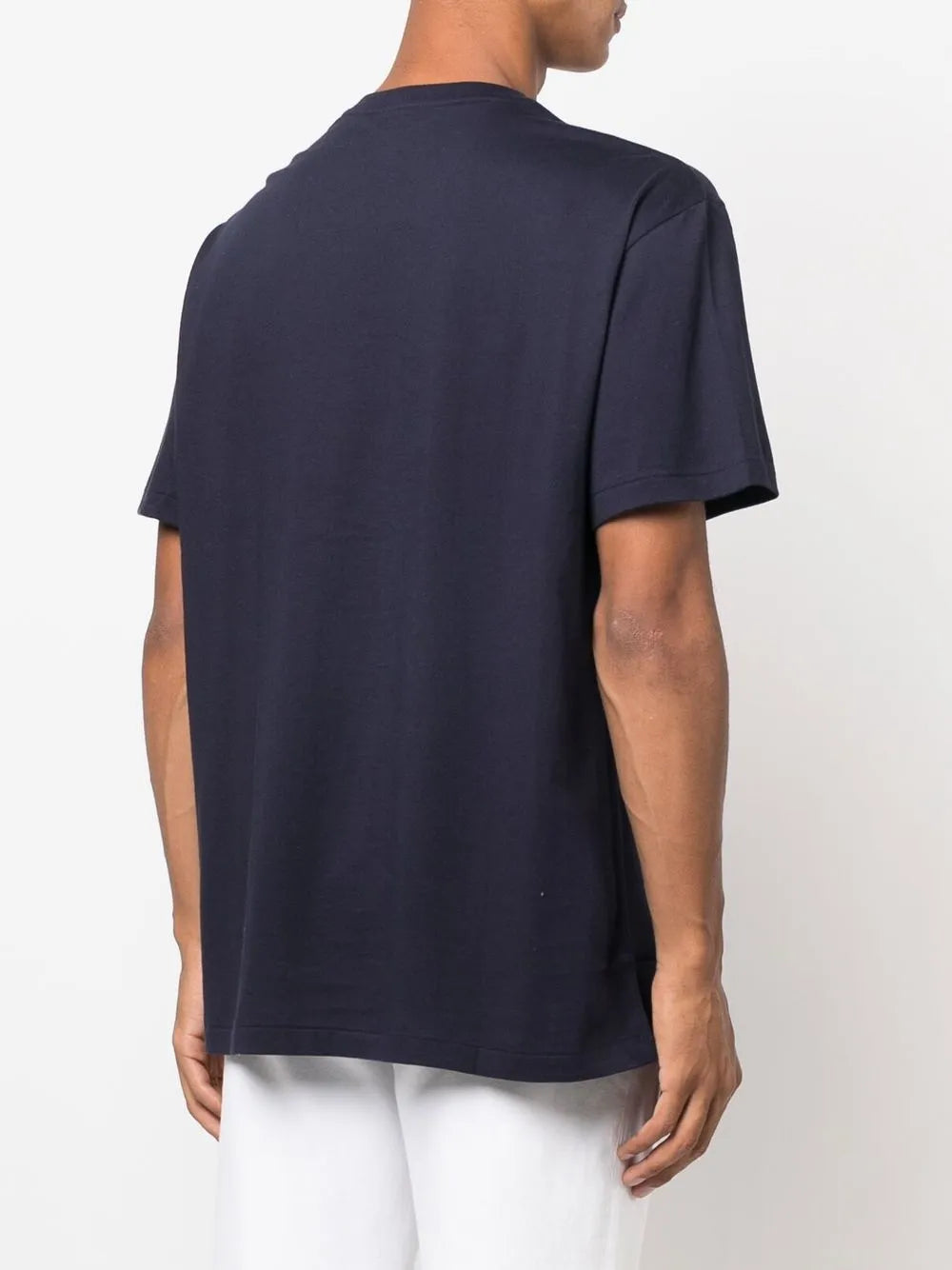 Navy shirt worn by a person, showing the shirt's fit