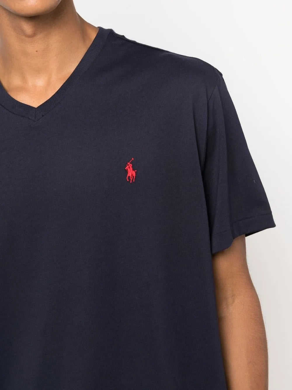 Close up of navy shirt, showing texture of the cotton fabric.