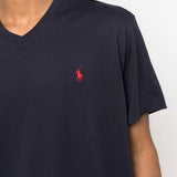 Close up of navy shirt, showing texture of the cotton fabric.