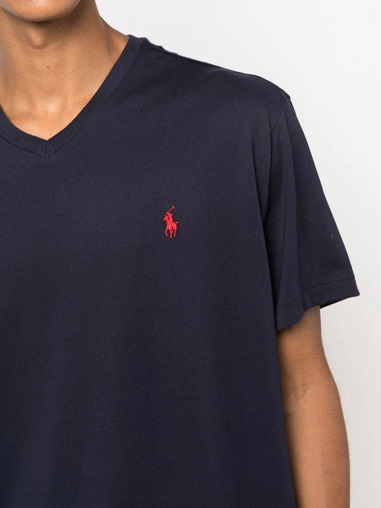 Close up of navy shirt, showing texture of the cotton fabric.