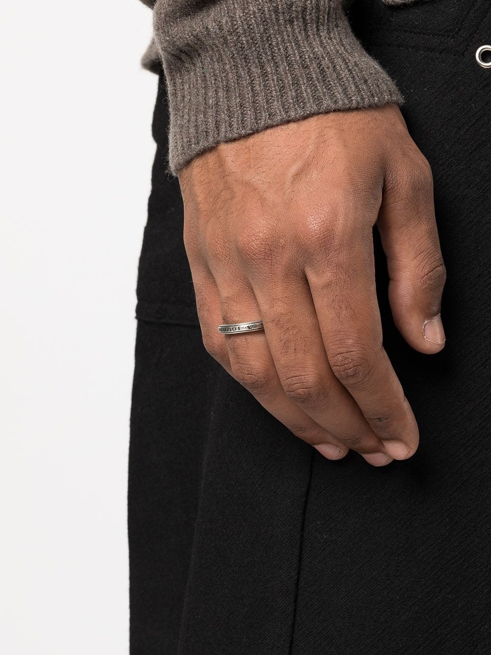 Silver ring worn by a person, showing the ring fit