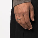 Silver ring worn by a person, showing the ring fit