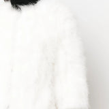 Close up of white coat, showing texture of the feather fabric