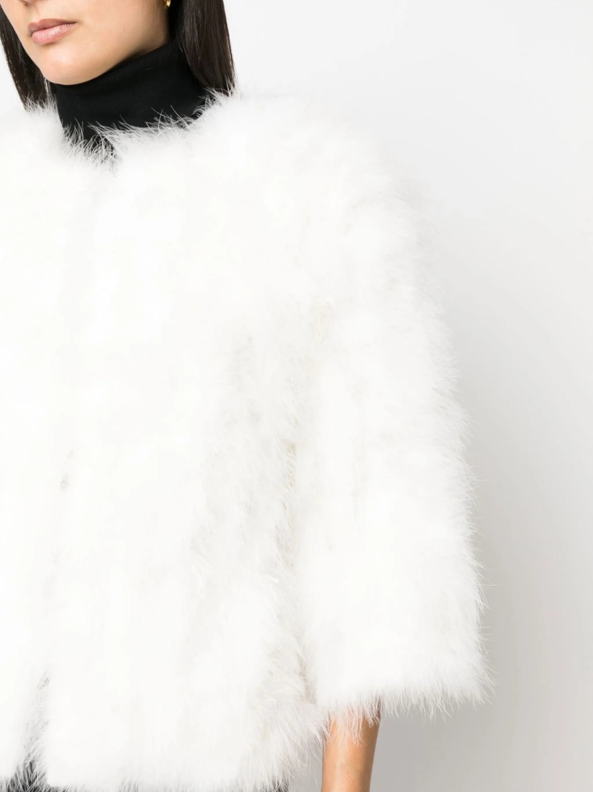 Close up of white coat, showing texture of the feather fabric