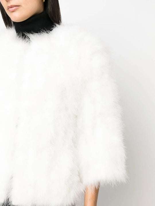 Close up of white coat, showing texture of the feather fabric