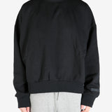 black hoodies worn by a person, showing the hoodies's fit
