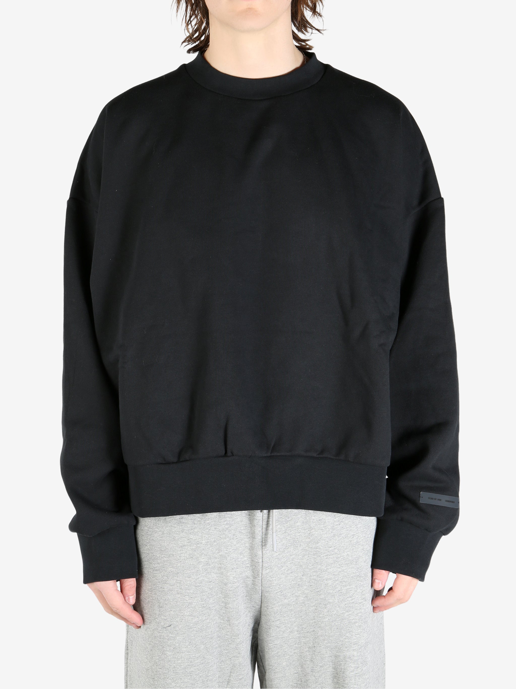 black hoodies worn by a person, showing the hoodies's fit
