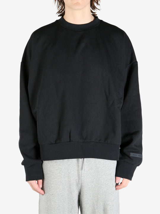 black hoodies worn by a person, showing the hoodies's fit
