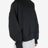 black hoodies worn by a person, showing the hoodies's fit
