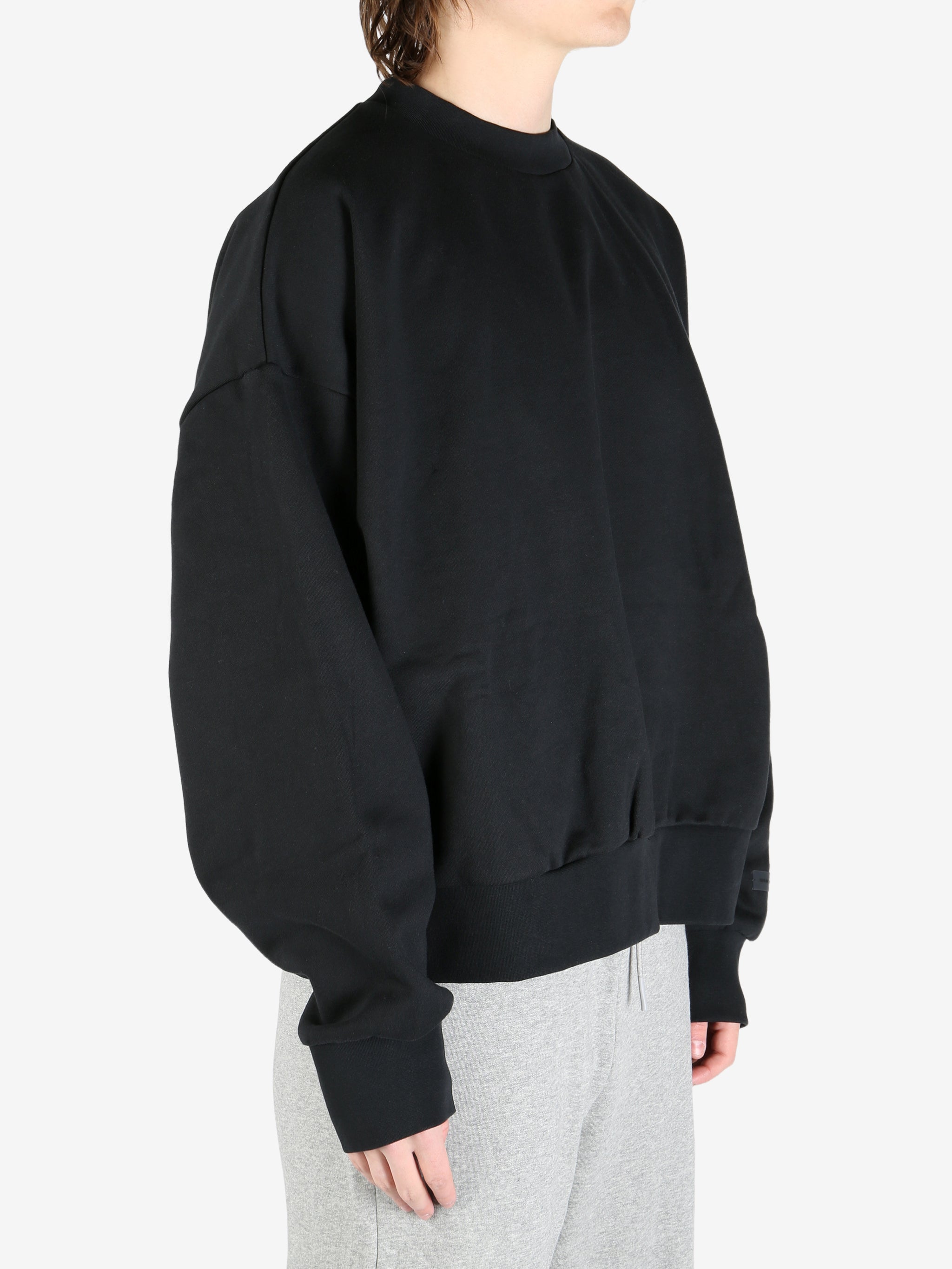 black hoodies worn by a person, showing the hoodies's fit
