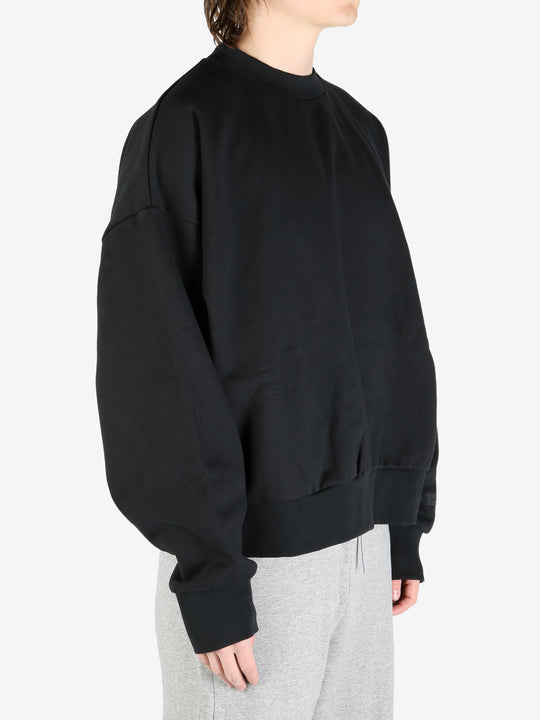 black hoodies worn by a person, showing the hoodies's fit
