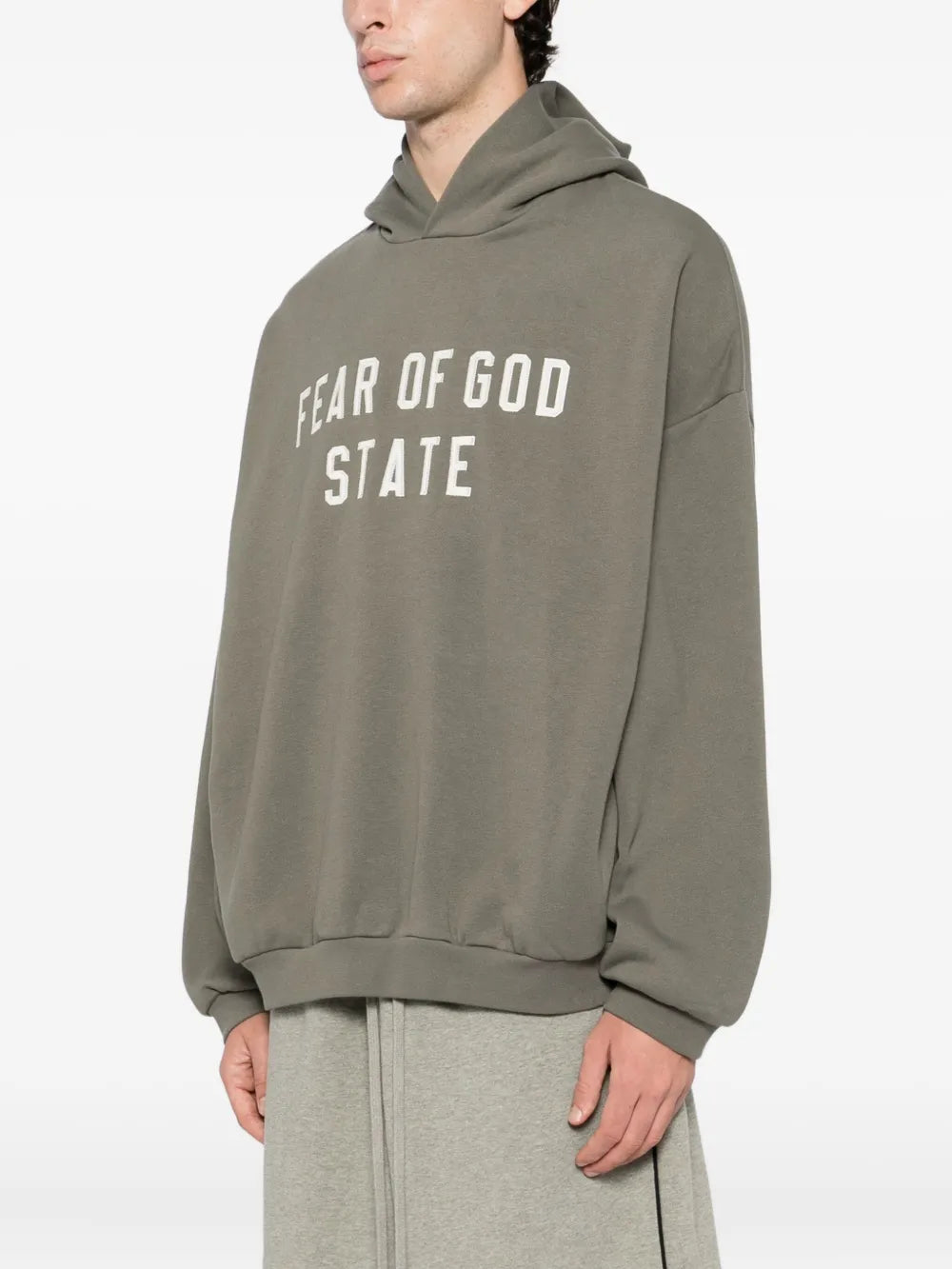 Grey hoodie worn by a person, showing the hoodie fit