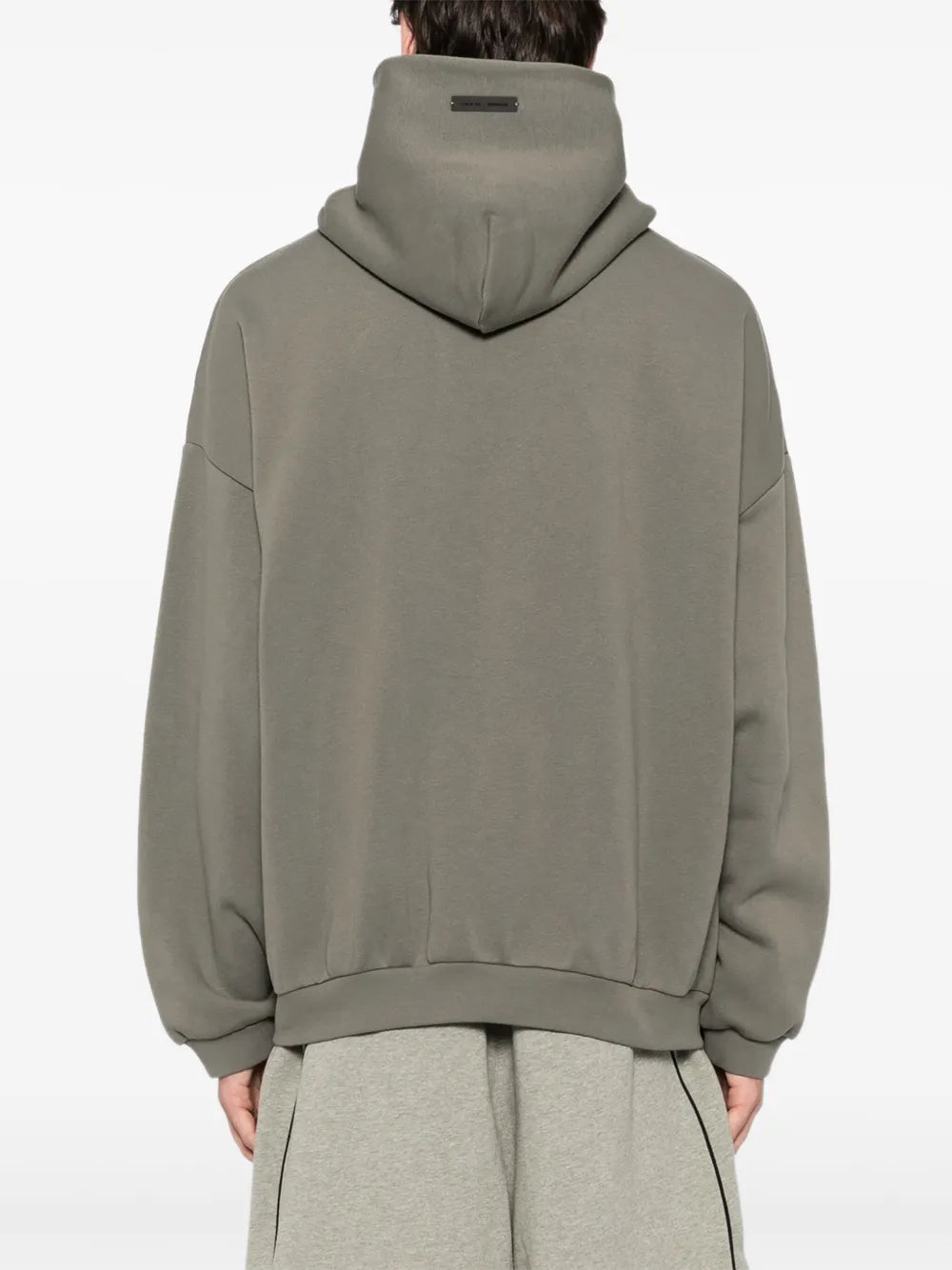 Grey hoodie worn by a person, showing the hoodie fit