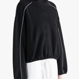 Black hoodie worn by a person, showing the hoodie's fit