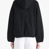 Black hoodie worn by a person, showing the hoodie's fit
