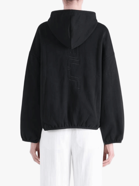 Black hoodie worn by a person, showing the hoodie's fit