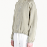 Tan hoodie worn by a person, showing the hoodie fit
