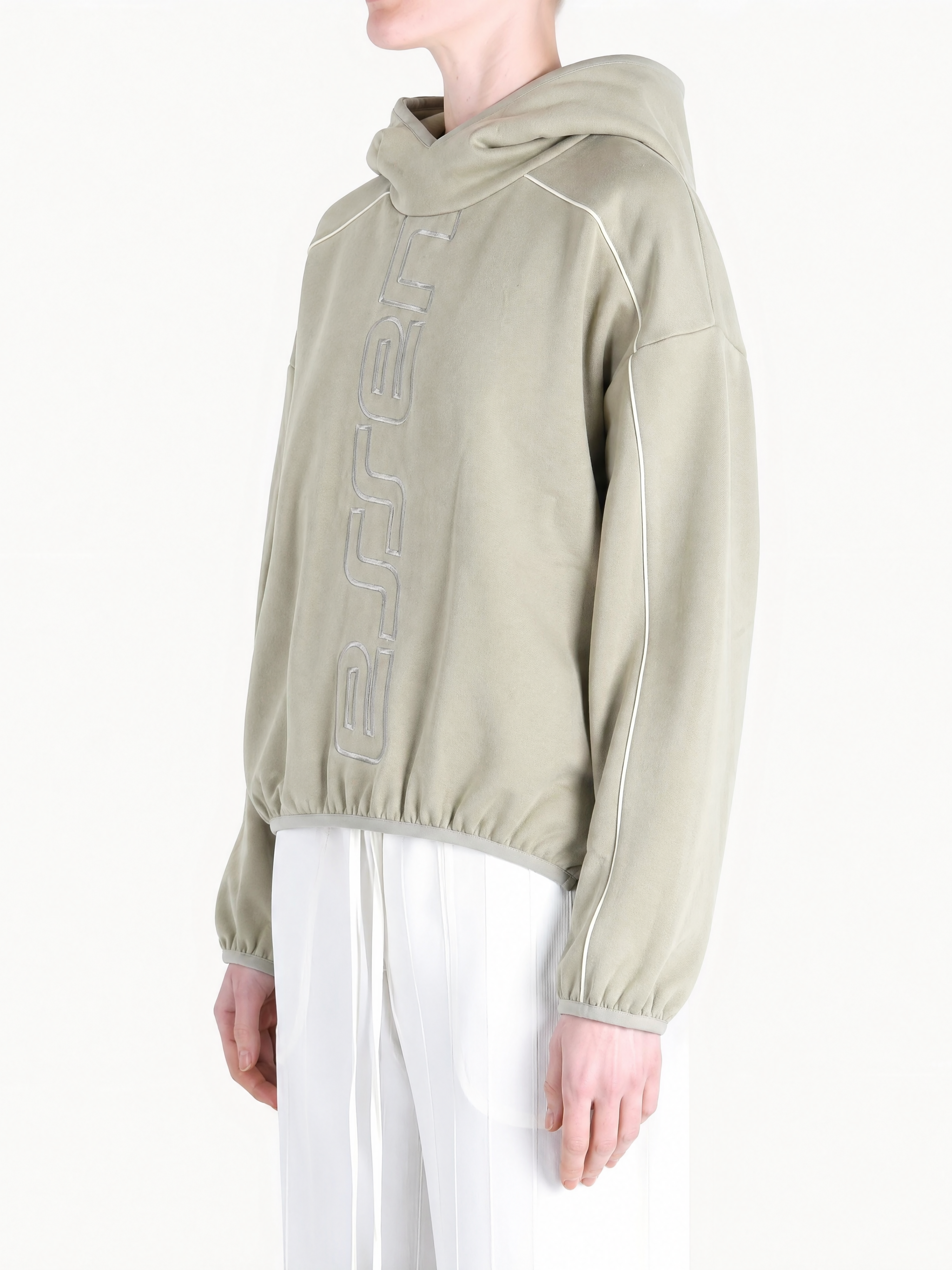Tan hoodie worn by a person, showing the hoodie fit