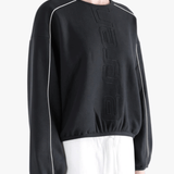 Black shirts worn by a person, showing the shirts fit