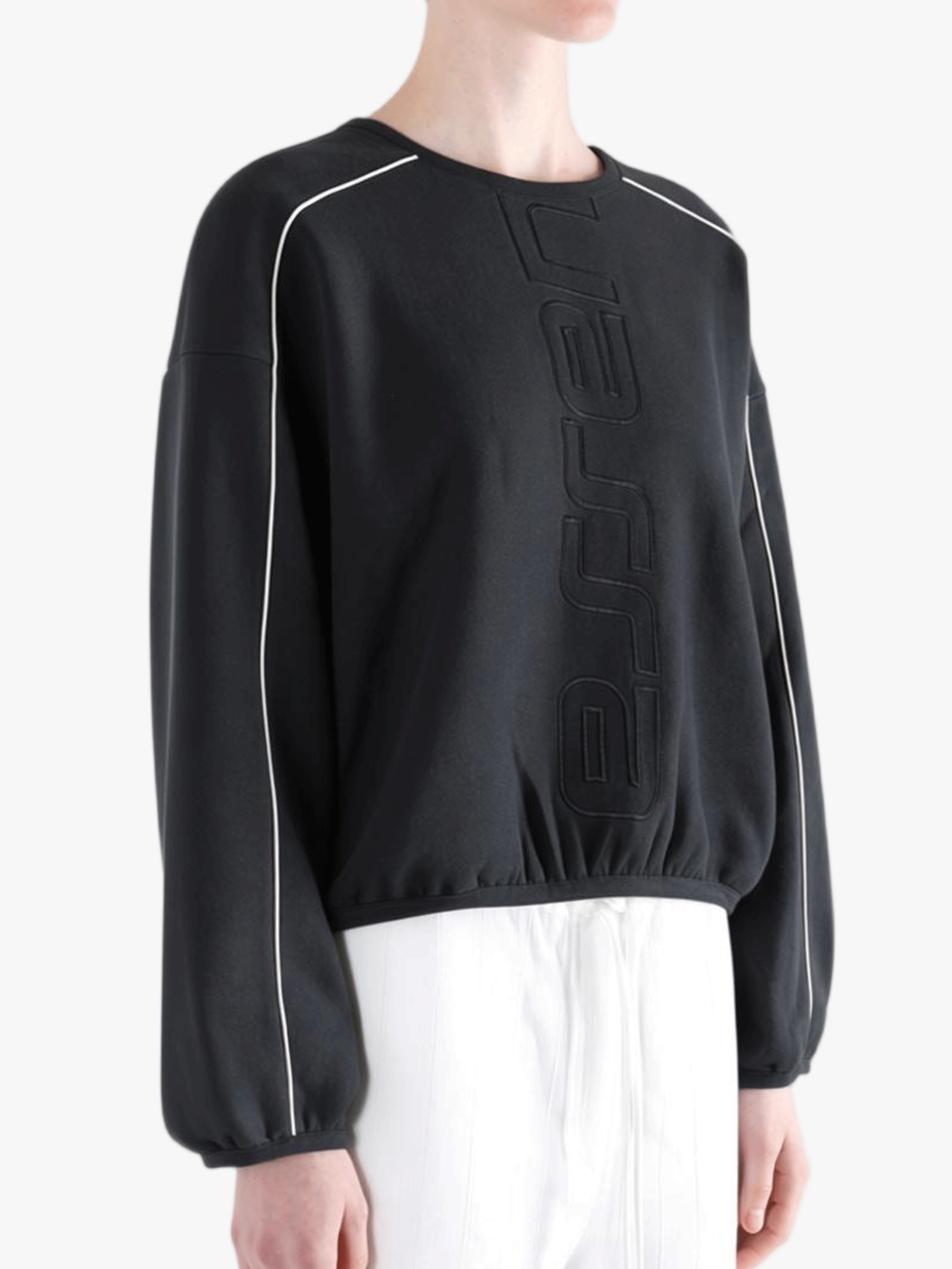 Black shirts worn by a person, showing the shirts fit