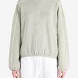 Tan hoodie worn by a person, showing the hoodie fit