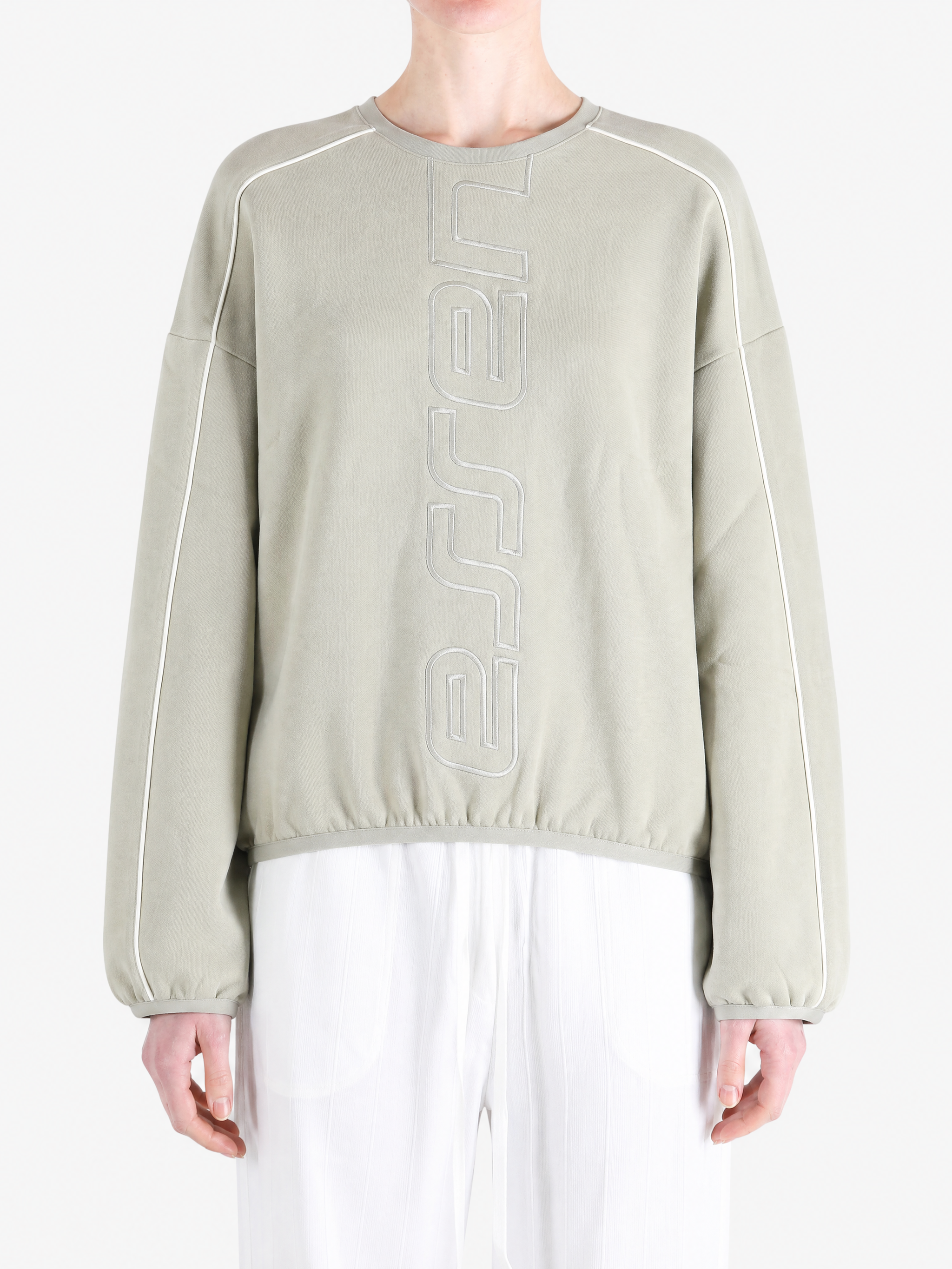 Tan hoodie worn by a person, showing the hoodie fit