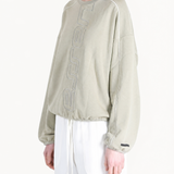 Tan hoodie worn by a person, showing the hoodie fit