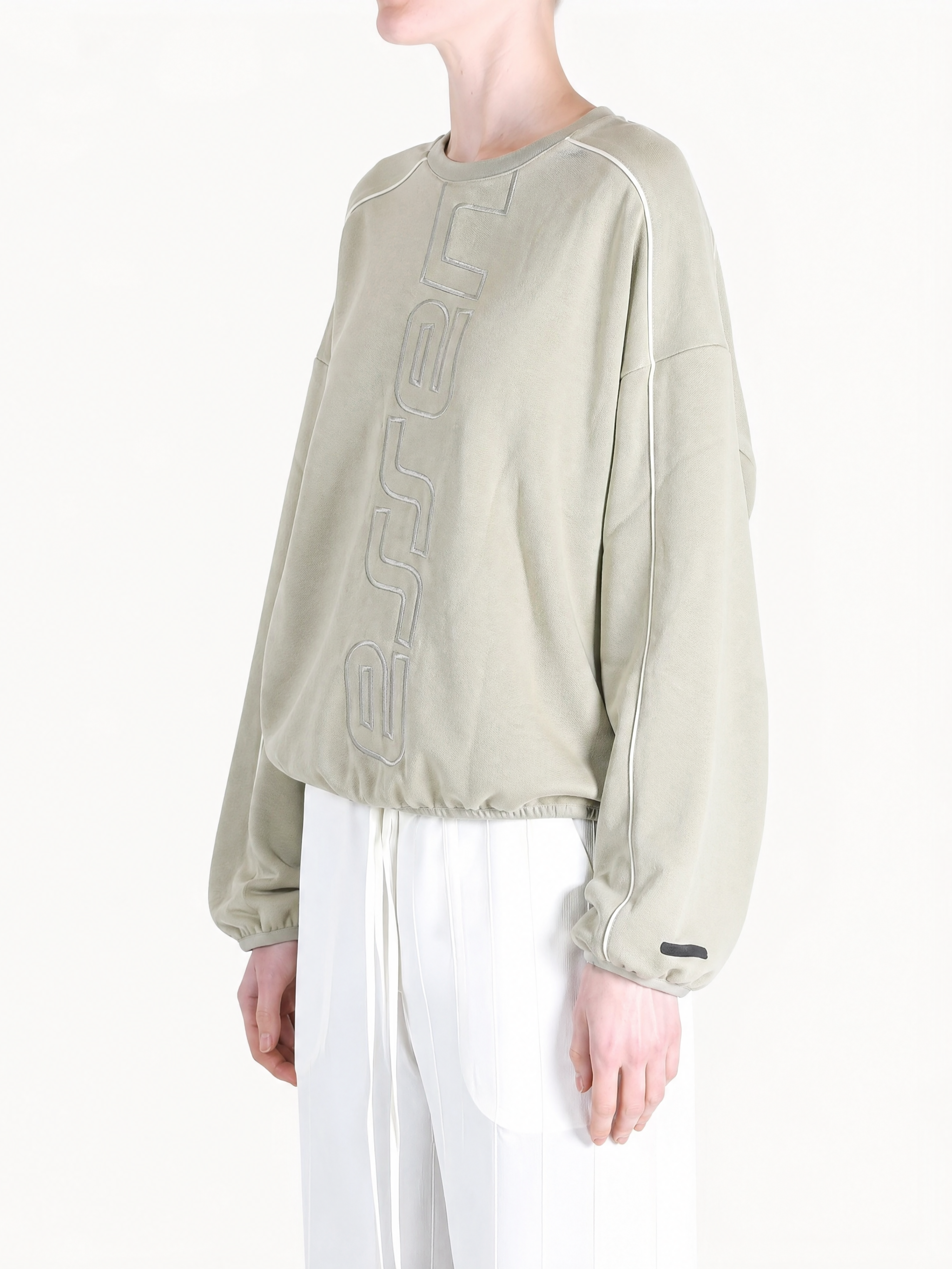Tan hoodie worn by a person, showing the hoodie fit