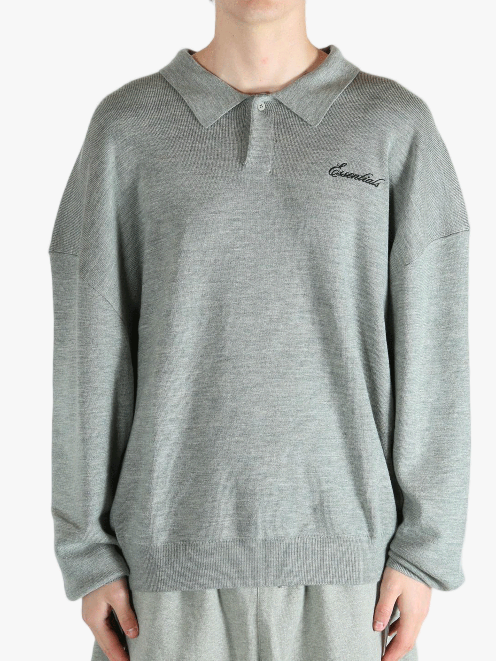 Grey knitwear worn by a person, showing the knitwear's fit